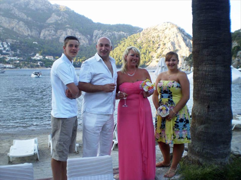 Mr and Mrs Holmes, their son and daughter Dominic and Antonia on the Beach at Hotel Turun&ccedil; after the blessing